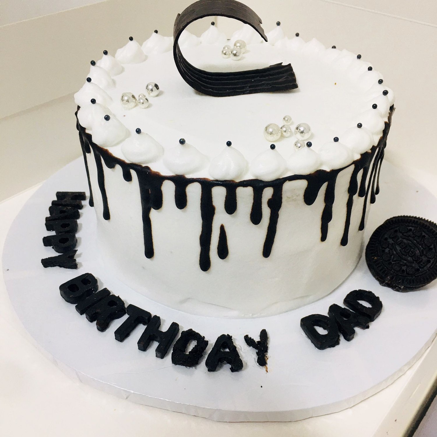 Black drip celebration cake made by Moh Bakes & Treats