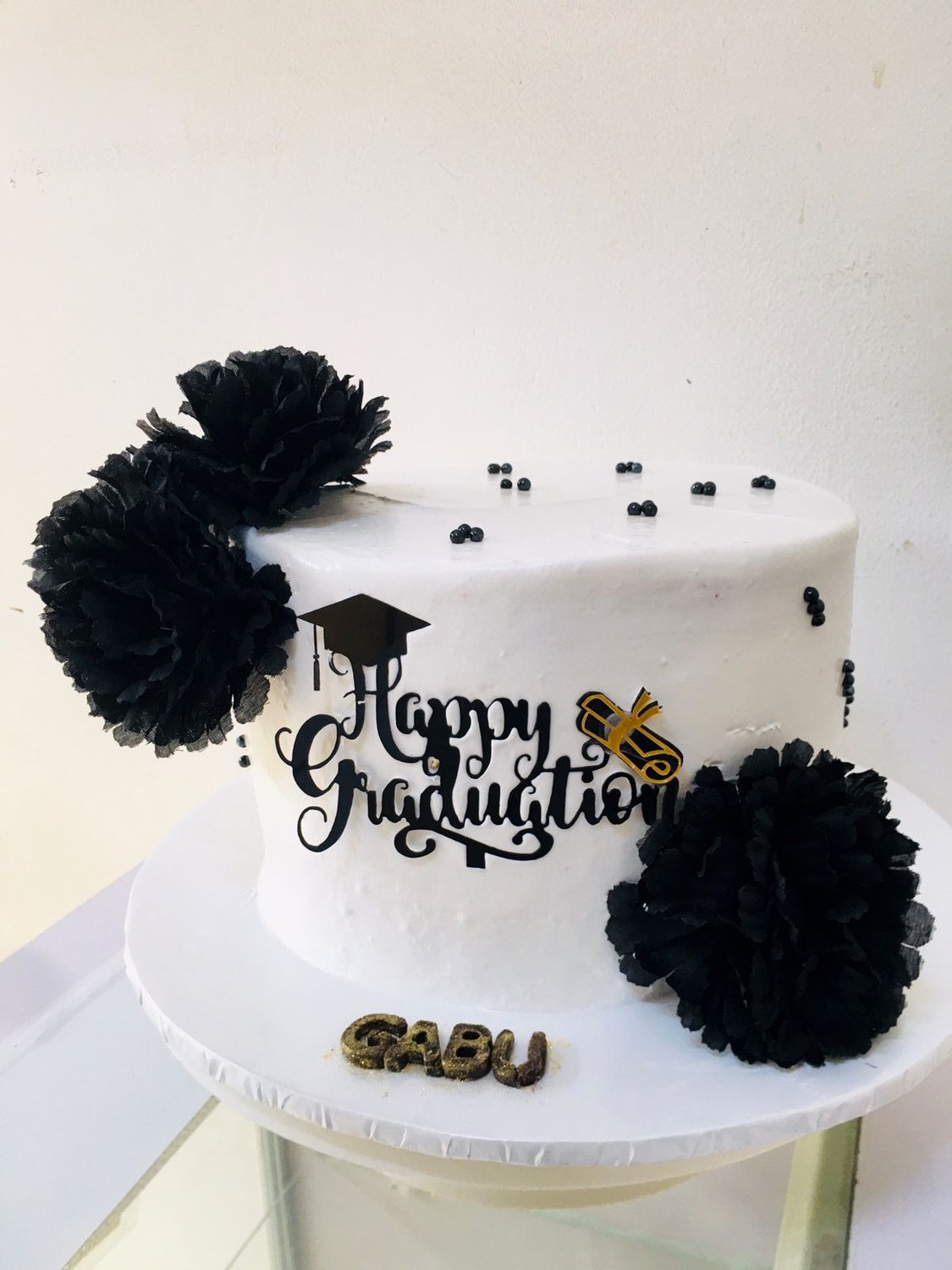 Black and white graduation cake made by Moh Bakes & Treats