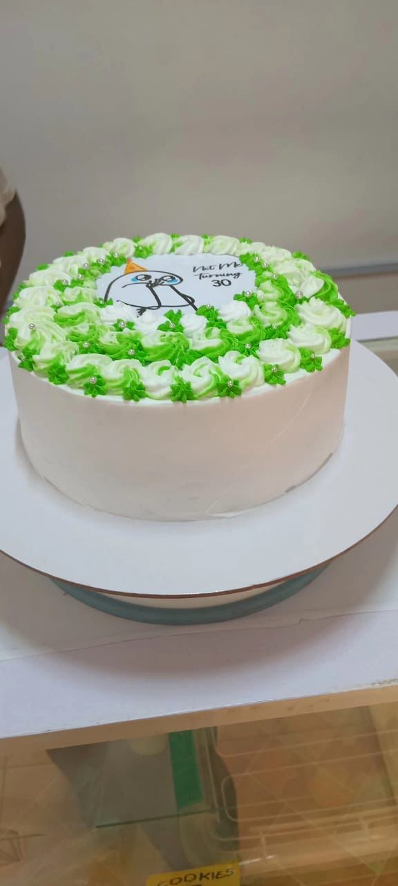 Green and white celebration cake made by Moh Bakes & Treats