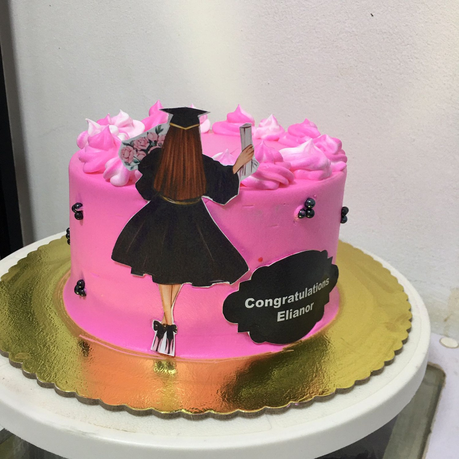 Pink graduation cake made by Moh Bakes & Treats