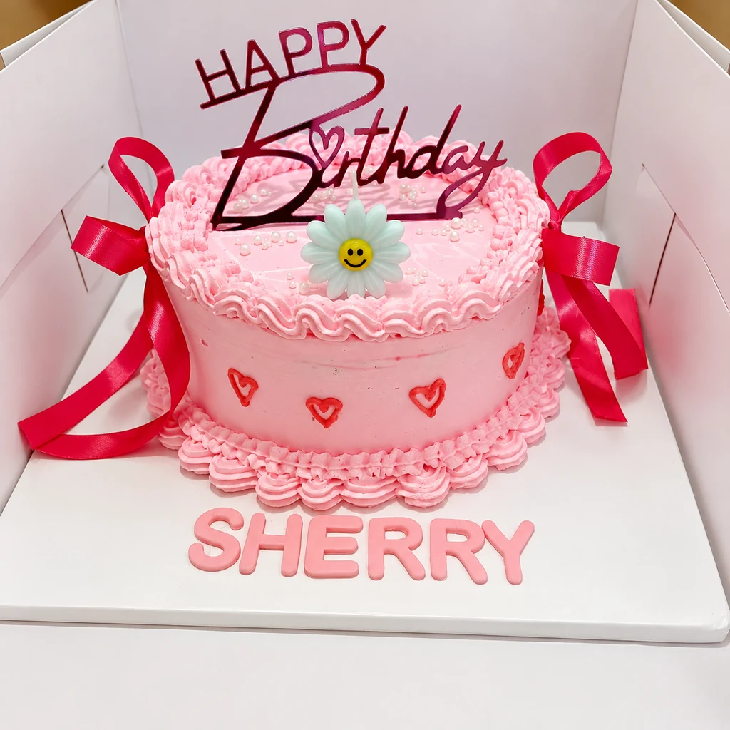 Pink birthday cake with red ribbon bows, smiley daisy, Happy Birthday topper and SHERRY lettering