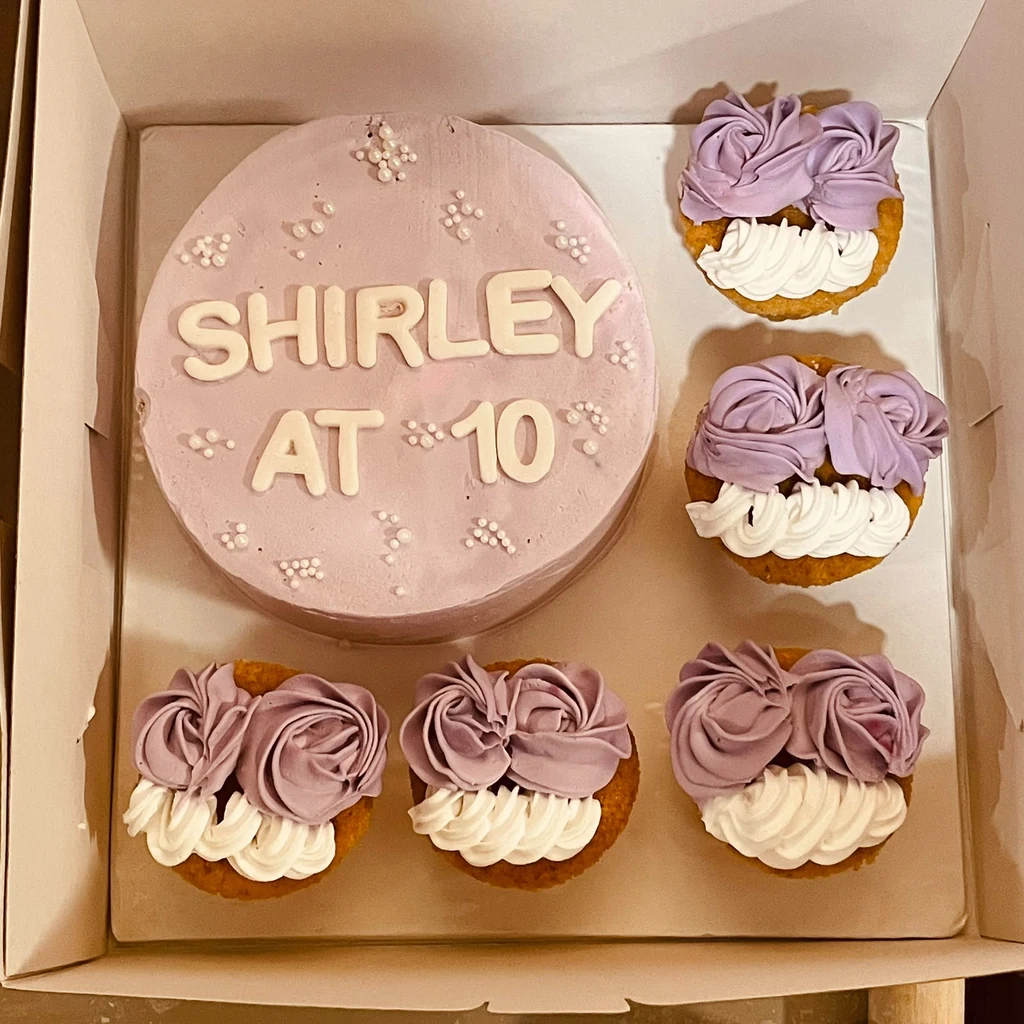 Lavender Shirley at 10 birthday cake with five matching lavender and white cupcakes