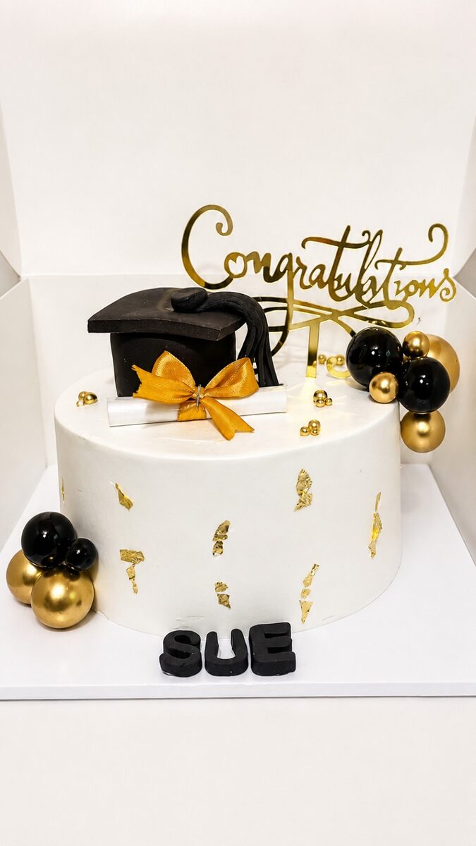 Black and gold graduation cake made by Moh Bakes & Treats