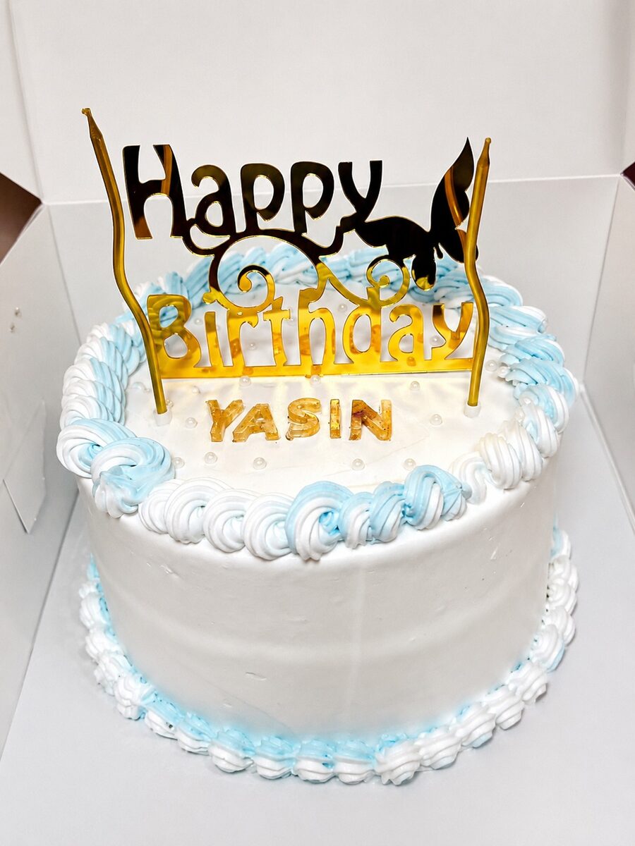 Blue and white birthday cake made by Moh Bakes & Treats