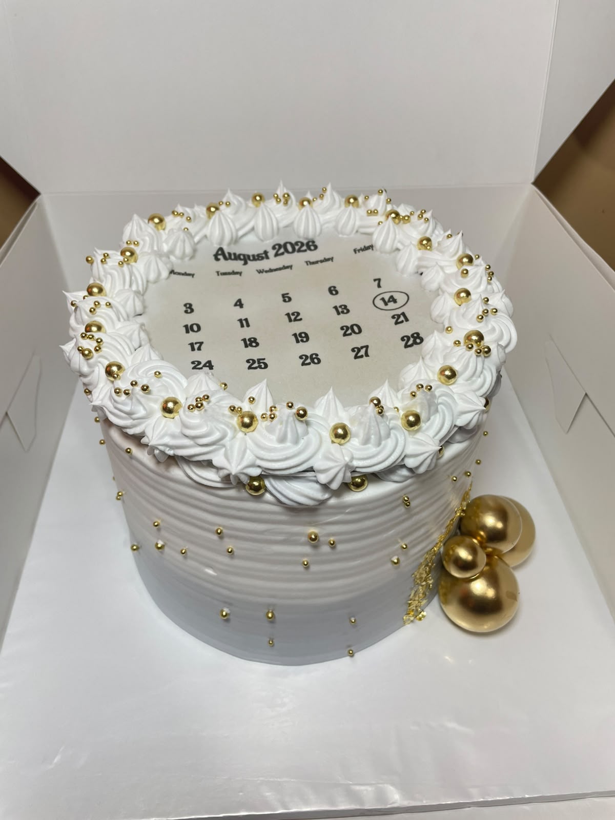 Calendar burn-away cake with hidden reveal made by Moh Bakes & Treats